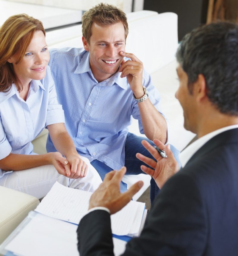 Couple-Getting-Quote A young couple consulting a financial planner at home